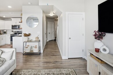 Kitchen with backsplash, stainless steel appliances, light countertops, light wood-type flooring, and recessed lighting