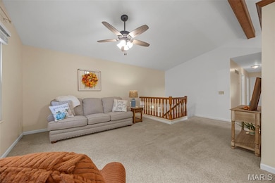 Living room featuring light colored carpet and a ceiling fan