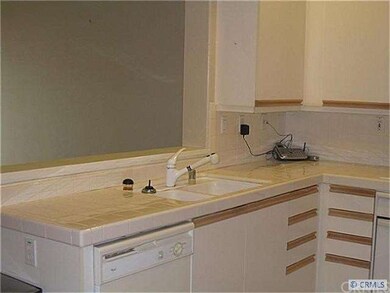 Kitchen Looks Out to Living Room & Dining Room