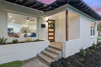 Doorway to property featuring brick siding