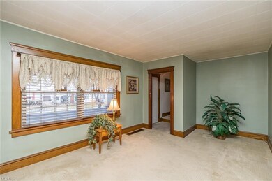Living room with newer carpet over hardwood
