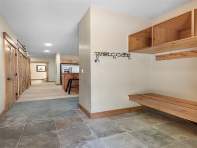 Benches, cubbies, and tiled flooring in the mud ro