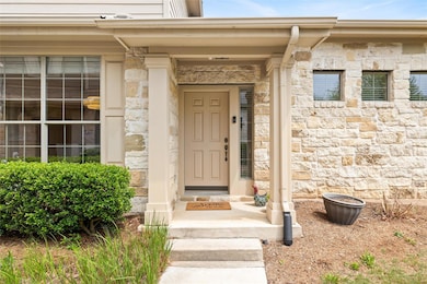 Entrance to property with stone siding