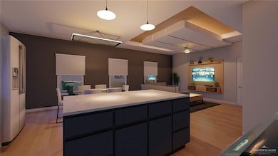 Kitchen featuring light countertops, light wood-style floors, a kitchen island, and high end refrigerator