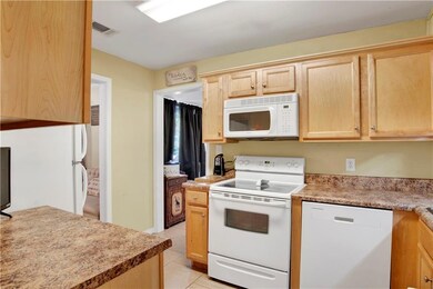 Kitchen with light tile patterned floors, light br