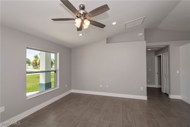 Empty room with recessed lighting, visible vents,