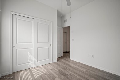 Unfurnished bedroom with wood finished floors, a c