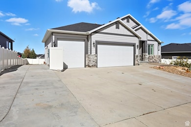 View of front of home with driveway, a garage, board and batten siding, and stone siding