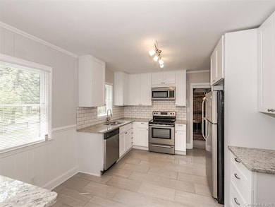 Stylish Kitchen has new cabinetry, new subway tile