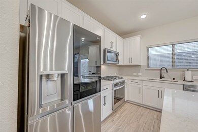 Modern kitchen with stainless steel appliances, in