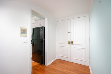 Double front door with kitchen on left