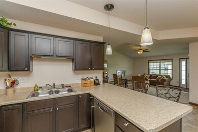 Kitchen looking out into great room with vaulted c