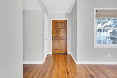 Entryway with healthy amount of natural light and wood finished floors