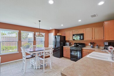 Kitchen featuring decorative light fixtures, sink,