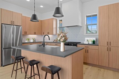 Kitchen featuring freestanding refrigerator, wall