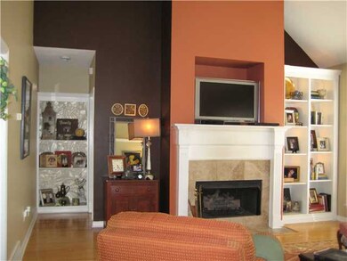 Large Great Room with cozy fireplace, gleaming har