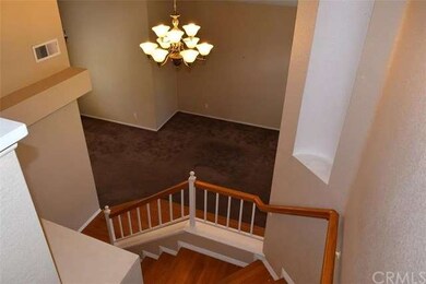 LOOKING DOWN STAIRWAY TOWARDS LIVING ROOM