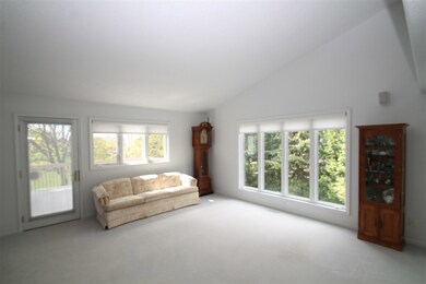 .....w/ vaulted ceiling, an abundance of natural light & exit to rear low-maintenance deck.