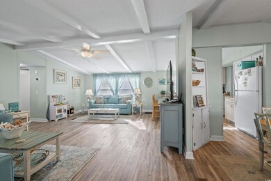 Living room with lofted ceiling with beams, ceilin