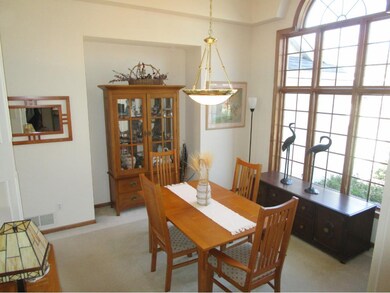 Open formal dining room with large windows and hig