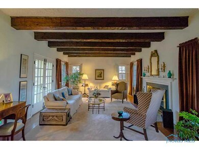 Living Room with Beamed Ceiling and Fireplace