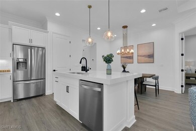 Kitchen featuring ornamental molding, visible vent