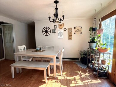 Dining room featuring plenty of natural light, vinyl plank flooring, an inviting chandelier,