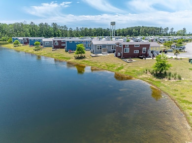 Aerial view of a nearby body of water and a tree filled landscape