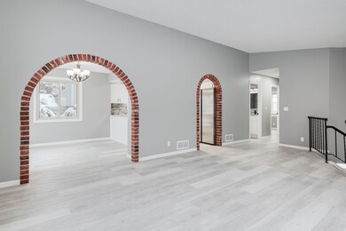 Brick framed doorways lead to the dining area and kitchen