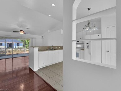 Kitchen featuring a peninsula, white appliances, c