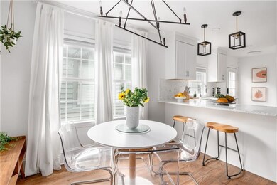 Dining room with plenty of natural light and light wood-style flooring