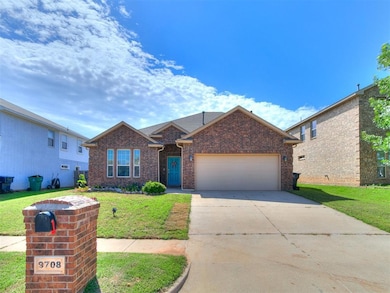 View of front of house featuring concrete driveway, an attached garage, and brick siding