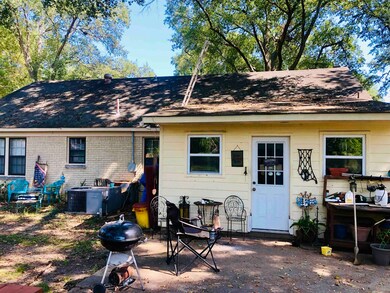 Rear view of house featuring cooling unit and a pa