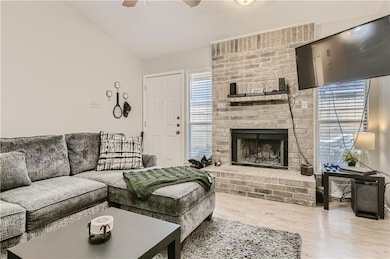 Living room featuring a ceiling fan, wood finishe
