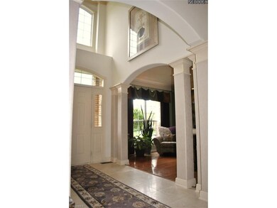 Two-story foyer with marble floor.