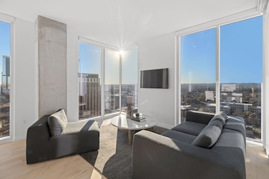Living area with floor to ceiling windows, wood f