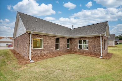 Back of property with a lawn