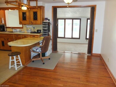 Dining room with wood floor open to the family roo