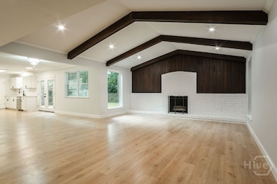 Living room with original wooden beams and firepla