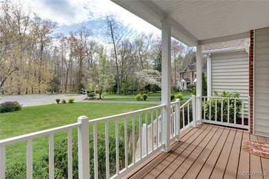 Deck with a lawn and covered porch