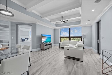 Living room with ceiling fan, light hardwood / wood-style floors, and ornamental molding