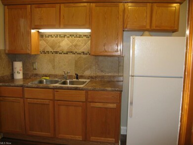 Beautifully remodeled Kitchen with décor tile and laminate floor.