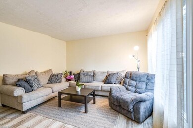 Living room with light hardwood flooring and a tex