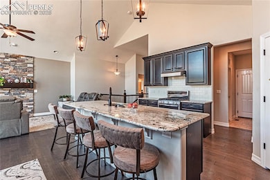 Kitchen featuring under cabinet range hood, stainl