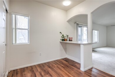 Kitchen with light countertops, baseboards, arched