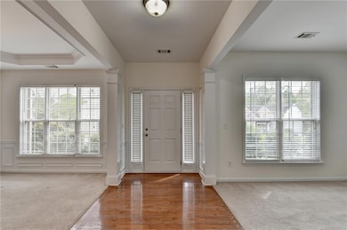 Foyer entrance with wood finished floors, decorati