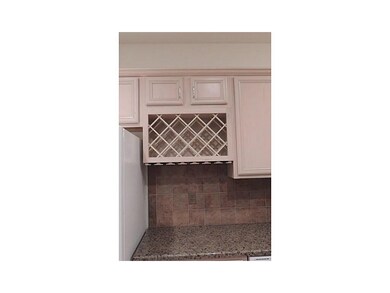 . Tile back splash wine rack in kitchen