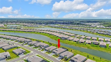 Aerial perspective of suburban area featuring a large body of water