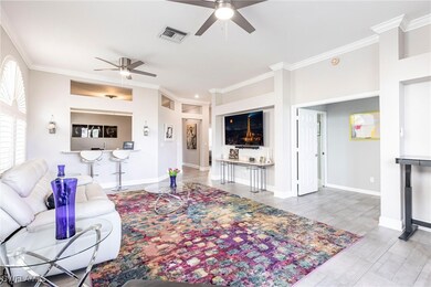 Living area with a ceiling fan and ornamental mold