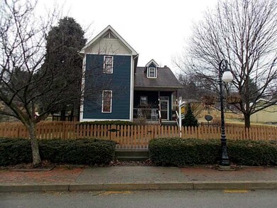 A real picket fenced doll house in the charming to